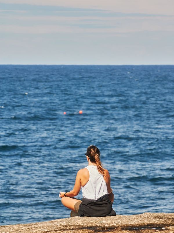 Woman meditating peacefully in a lotus position.